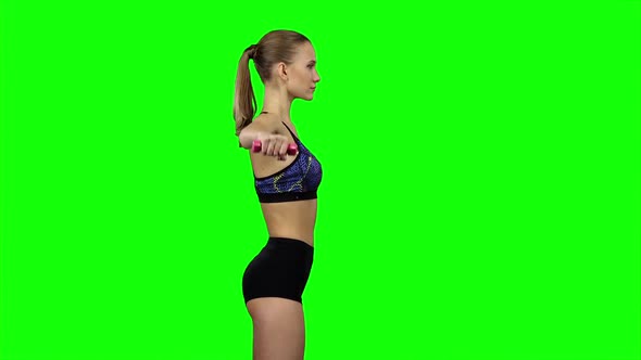 Girl with Dumbbells in Profile. Green Screen