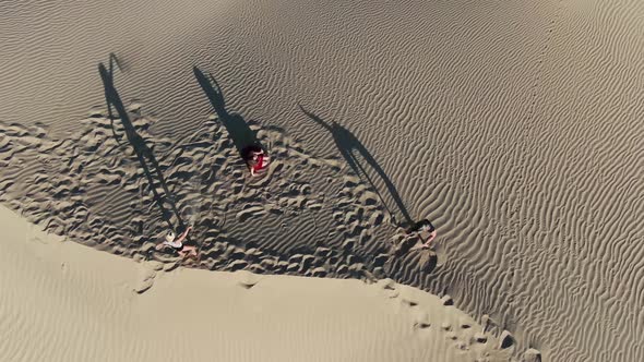 Models on Top of a Sand Dune Dancing and Posing Rub Al Khali Desert