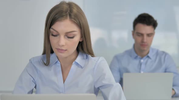 Thumbs Up By Young Businesswoman in Office