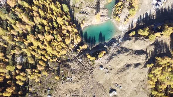 drone shot of a crystal clear deep blue turquoise mountain lake in the swiss alps (lac bleu)