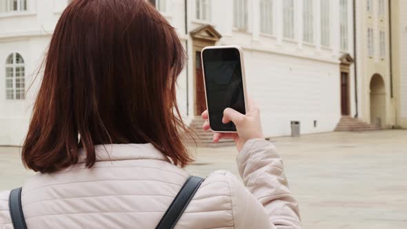 Woman Tourist in Respirator Filming a Video in Prague Castle