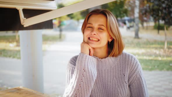 Young Happy Hipster Student in Sitting at Street Cafe Alone Enjoying Weekend