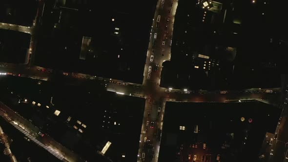 AERIAL: Slow Overhead Shot of City at Night with Lights and Traffic, Cologne, Germany 