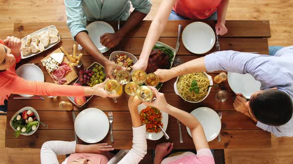 Group of People Eating and Drinking Wine at Table 23