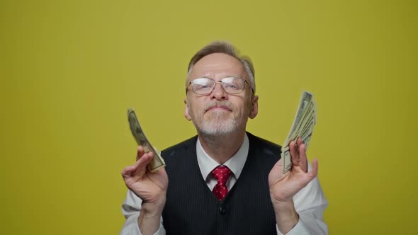 Portrait of grey haired man with dollars