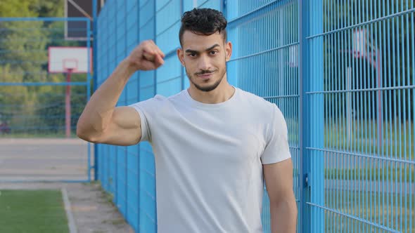 Attractive Arab Bearded Athletic Guy in White Tshirt Shows Big Manly Muscles Demonstrates Triceps