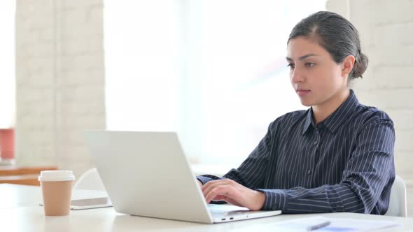 Sick Young Indian Woman with Laptop Coughing 