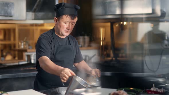 Asian Male Chef Cooking Food at Frying Pan Filling Water at Cuisine