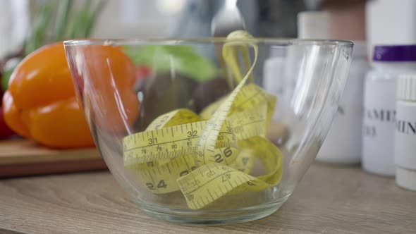 Closeup Transparent Bowl with Fork Stirring Measuring Tape