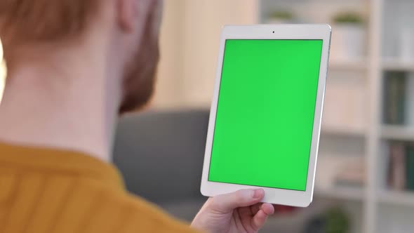 Rear View of Man Using Tablet with Chroma Screen 