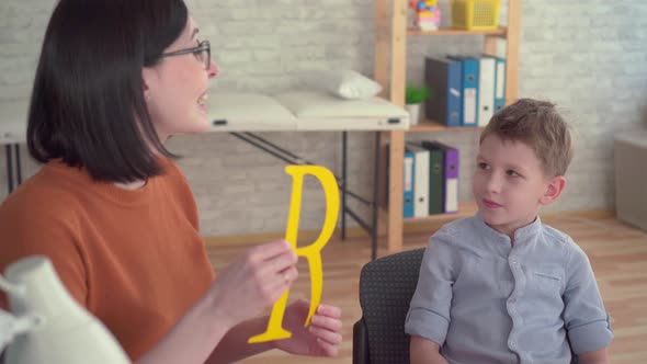 Little Boy at a Reception of a Speech Therapist Close Up