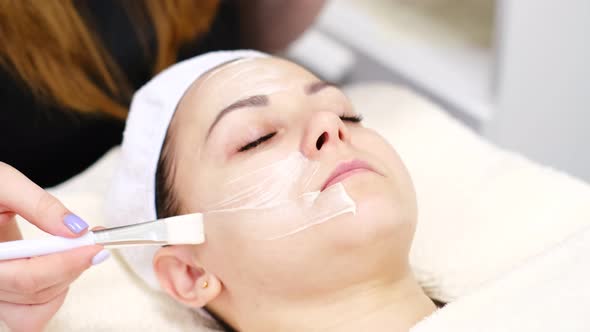 Beautician Doctor Making Skincare Procedure in Beauty Salon Portrait of Girl Closeup