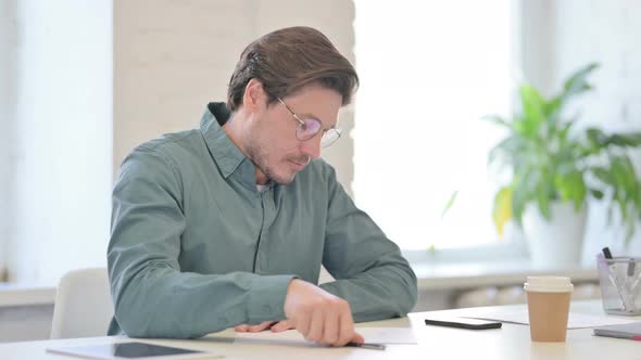 Middle Aged Man Trying to Write on Paper Failure