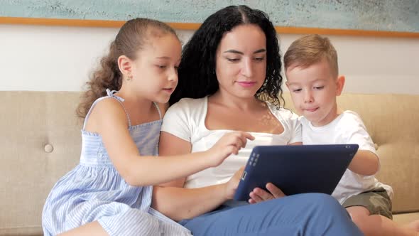 Happy Family,mom and Cute Children Watch Tablet or Laptop,mother Plays with Children at Home