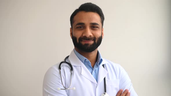 Smiling Male Indian Doctor Pediatric Physical Therapist Wearing a White Medical Gown