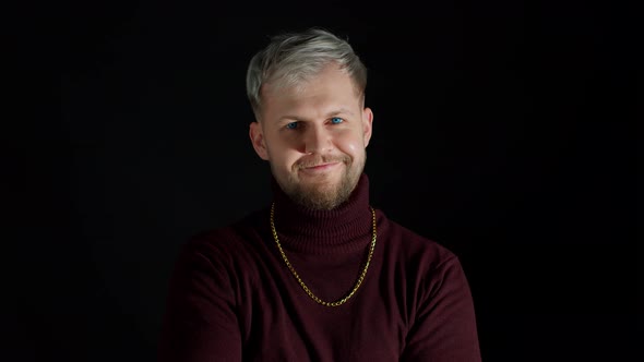 Smiling Cheerful Young Man in Trendy Stylish Clothes Holding Hands Crossed on Black Background