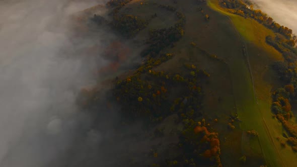 Drone Flight at Sunrise Over Beautiful Autumn Landscape of Mountain Range with Sea of Clouds in