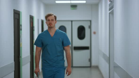 Serious Doctor Walking Down Hospital Corridor