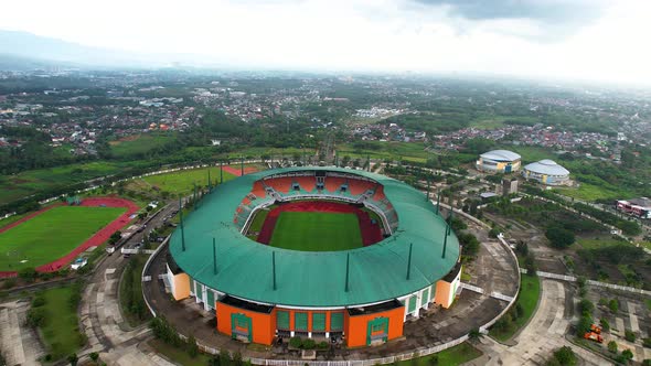 Aerial View of The largest stadium of Pakansari Bogor from drone and noise cloud.