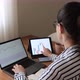 business woman following charts with laptop at home. Stockbroker young woman working at home. - VideoHive Item for Sale