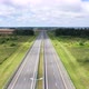 Empty Highway with Two Lanes and Streetlights Across Meadow - VideoHive Item for Sale