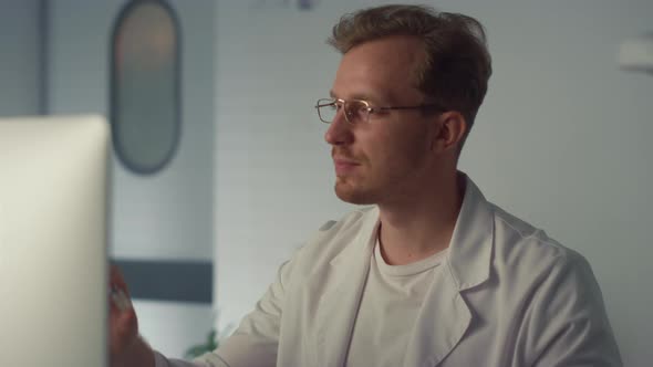 Physician Holding Vaccine Vial in Hospital Close Up