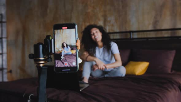 Portrait of Young African American Woman Blogger Streaming Live Using Smartphone Talking to