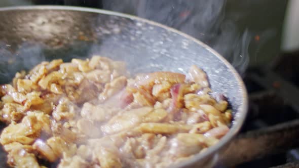 Slow motion of shawarma cooking in a frying pan