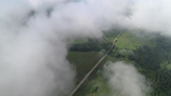 Very Slow and Smooth Flight Above the Clouds. Slow Decrease in Height, Followed By Flying Into the