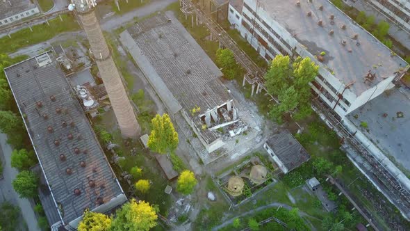 Abandoned Warehouses And Factories. Top view of the abandoned factory with broken windows and walls