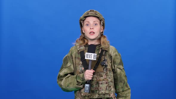 Woman Journalist in Camouflage Protective Gear Uses a Digital Screen Tablet and Works in Extreme