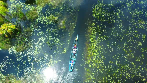 Top down shot of boat on Amansuri Lake in Ghana alt