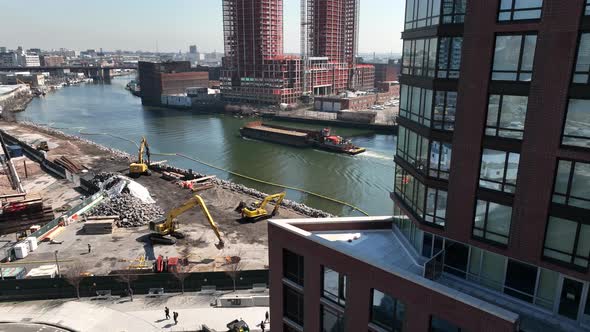 An aerial view passing a new high-rise apartment building in Long Island City, NY on a sunny day. Th