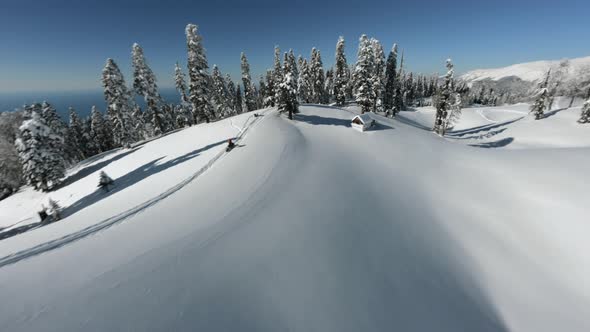 Aerial View Sports FPV Drone Man Extreme Leisure Riding Snowmobile at Abkhazia Mamzishkha Mountain