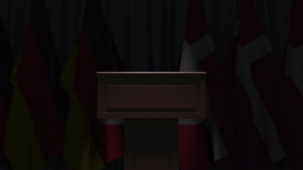 Many Flags of Denmark and Germany Behind Speaker Tribune alt