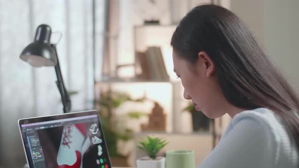 Close Up Of Asian Female Footwear Designer Stretching While Designing Shoe On A Laptop At Home