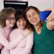 Woman with Down Syndrome with Her Mom Taking Photos with the Phone - VideoHive Item for Sale