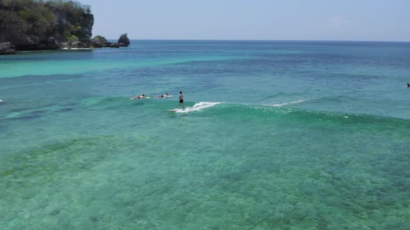 Man Who Straddled the Wave Between Other Surfers Bali Indonesia