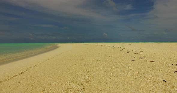 Wide angle above abstract shot of a sandy white paradise beach and aqua turquoise water background i