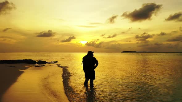 Single female enjoys life on beautiful resort beach adventure by aqua blue water and white sandy bac