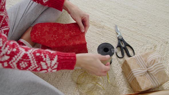 Woman Packing Christmas Gifts Top View