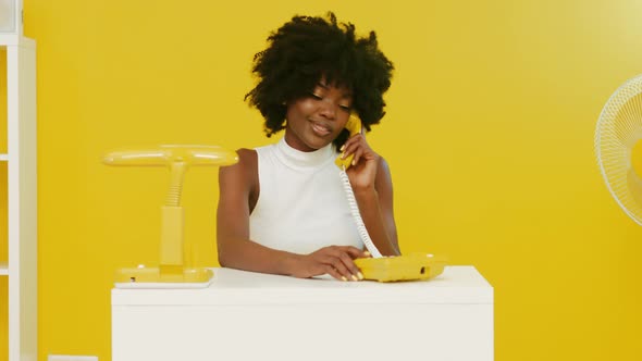 AfroAmerican Woman Has Phone Conversation In Creative Office