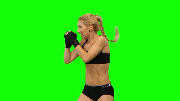 Boxer Standing in the Front and Make Swings and Kicks. Green Screen. Side View. Close Up