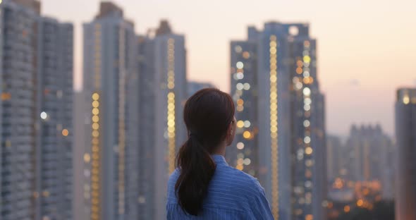 Woman Look at The Apartment Building in City