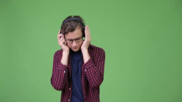 Young Handsome Teenage Nerd Boy Listening To Music