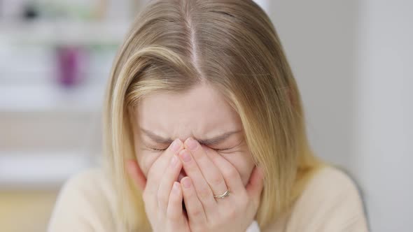 Closeup Face of Desperate Depressed Young Woman Crying Indoors