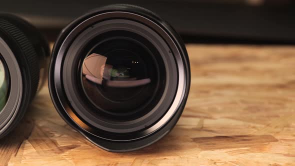 Different Kinds Of Camera Lens On Wooden Table. - close up, slider left