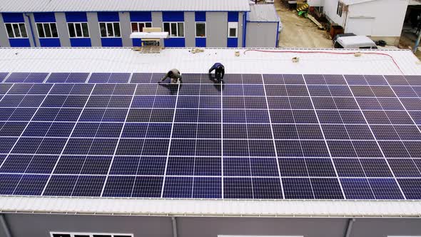 Solar Technician Installing Solar Panels on House Roof