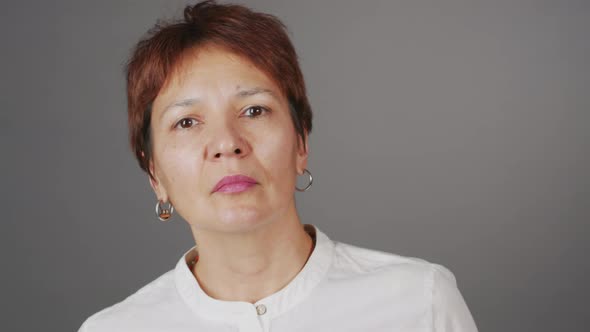 Studio Portrait of Serious Short Haired Mature Woman