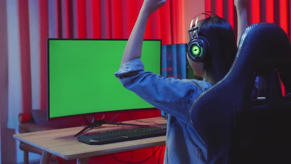 Young Asian Girl Gamer Playing Video Game And Win With Green Screen Display